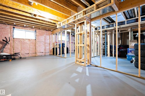 The unfinished basement features exposed wooden joists, a poured concrete floor, and framed walls, offering customization potential - 6303 169 Avenue, Edmonton, AB - Indoor Photo Showing Basement