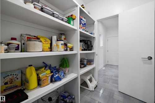 The property features a spacious pantry with extensive shelving, providing ample storage - 6303 169 Avenue, Edmonton, AB - Indoor With Storage