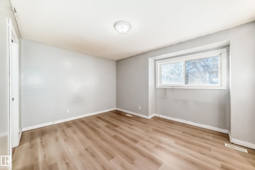 Unfurnished bedroom with light wood-type flooring - 11609 125 Street, Edmonton, AB - Indoor Photo Showing Other Room