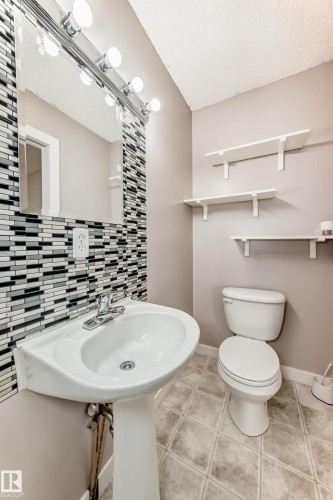 Bathroom with light tile patterned floors and a textured ceiling - 11609 125 Street, Edmonton, AB - Indoor Photo Showing Bathroom