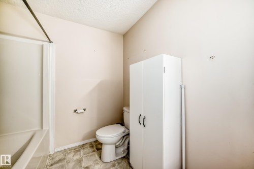 Bathroom with a textured ceiling and shower / bath combination - 11609 125 Street, Edmonton, AB - Indoor Photo Showing Bathroom