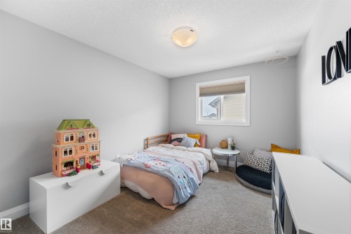 Bright room featuring light grey walls and neutral carpet flooring - 4917 Charles Point(E), Edmonton, AB - Indoor Photo Showing Bedroom