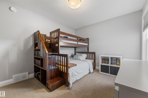 This room features light-colored walls and carpeted flooring - 4917 Charles Point(E), Edmonton, AB - Indoor Photo Showing Bedroom