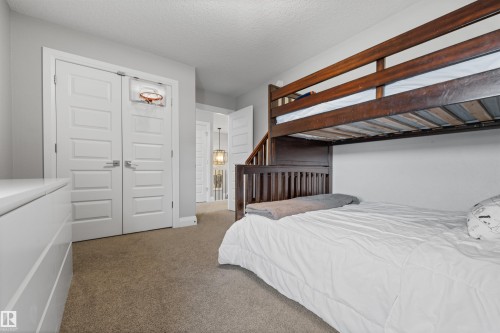 The room features light grey walls and carpeted flooring - 4917 Charles Point(E), Edmonton, AB - Indoor Photo Showing Bedroom