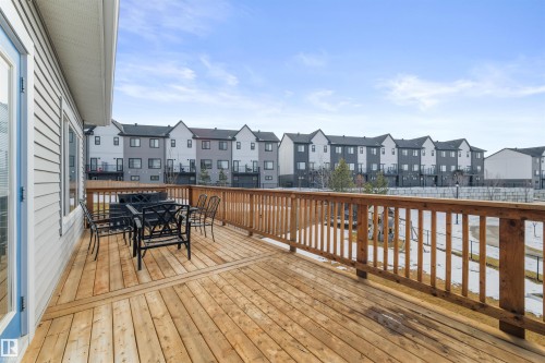 The property features an outdoor wooden deck with a wooden railing - 4917 Charles Point(E), Edmonton, AB - Outdoor With Exterior