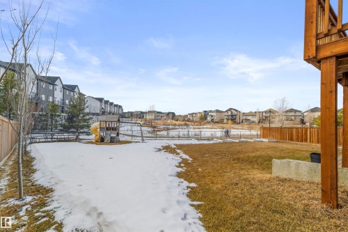 The property features a spacious backyard with a wooden fence and a wooden deck structure - 4917 Charles Point(E), Edmonton, AB - Outdoor