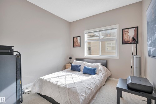 The room features a window with white trim, light-colored walls, and carpeting - 106 3040 Spence Wynd, Edmonton, AB - Indoor Photo Showing Bedroom
