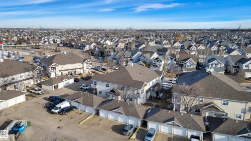 Aerial view of the neighborhood featuring residential buildings with sloped roofs and dedicated parking areas - 106 3040 Spence Wynd, Edmonton, AB - Outdoor With View