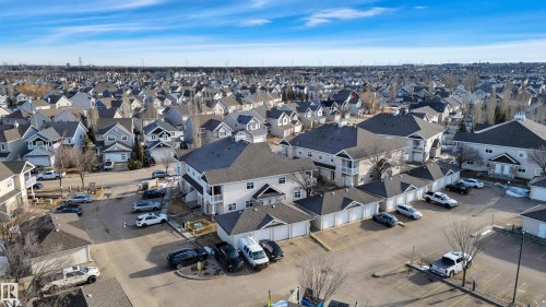 The property features a well-maintained exterior with a dark-colored roof and light-colored siding - 106 3040 Spence Wynd, Edmonton, AB - Outdoor With View