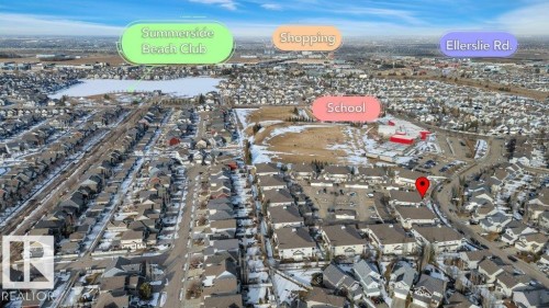 Aerial view of the surrounding area, featuring a body of water, a school, and shopping facilities - 106 3040 Spence Wynd, Edmonton, AB - Outdoor With View