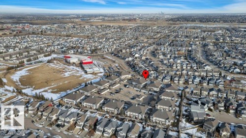 Aerial view showcasing the residential neighbourhood with a commercial area visible - 106 3040 Spence Wynd, Edmonton, AB - Outdoor With View