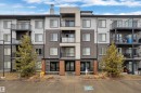 The property features a modern exterior with varied siding textures and colors, individual balconies with black railings, and a prominent main entrance - 128 390 Windermere Road, Edmonton, AB  - Outdoor With Facade 
