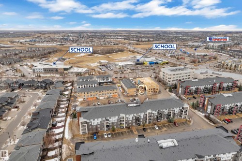 Aerial view of the community, highlighting nearby schools and a commercial center - 128 390 Windermere Road, Edmonton, AB - Outdoor With View