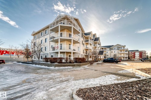 This property features a multi-story building with balconies and a parking area - 208 2204 44 Ave, Edmonton, AB - Outdoor With Balcony With Facade