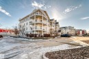 This property features a multi-story building with balconies and a parking area - 208 2204 44 Ave, Edmonton, AB  - Outdoor With Balcony With Facade 