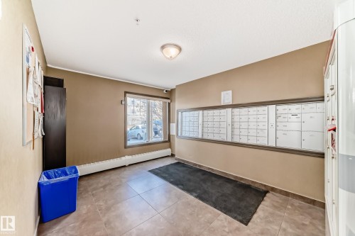 This inviting common area features neutral-toned walls, tile flooring, and a window that provides natural illumination - 208 2204 44 Ave, Edmonton, AB - Indoor Photo Showing Other Room