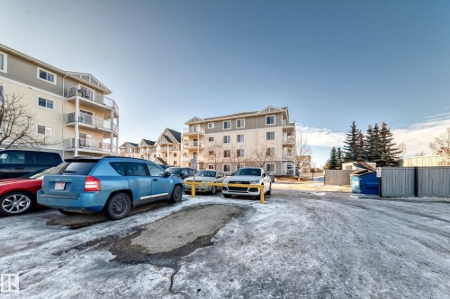 The property is part of a complex featuring multi-story buildings with balconies - 208 2204 44 Ave, Edmonton, AB - Outdoor With Balcony