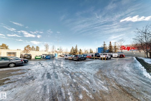 Parking area featuring asphalt surfacing and a clear blue sky - 208 2204 44 Ave, Edmonton, AB - Outdoor With View