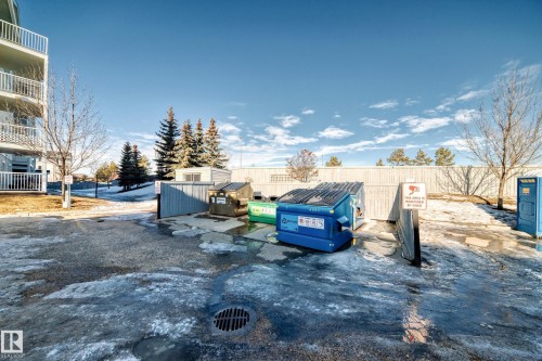 The property features a dedicated waste disposal area with bins - 208 2204 44 Ave, Edmonton, AB - Outdoor With Balcony