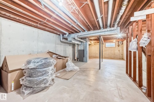 The property features a spacious unfinished basement with concrete walls and flooring, offering potential for customization - 11393 22 Avenue, Edmonton, AB - Indoor Photo Showing Basement