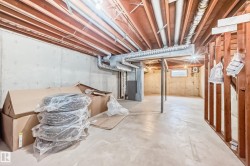The property features a spacious unfinished basement with concrete walls and flooring, offering potential for customization - 