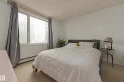 This room features a large window with white trim, light-colored walls, and neutral carpet flooring - 