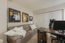 This room features light-colored walls and carpeted flooring, providing a neutral backdrop - 
