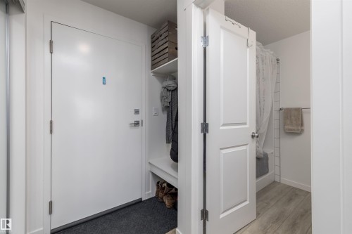 Entryway with a built-in bench and shelving, providing practical storage solutions - 101 860 Secord Blvd, Edmonton, AB - Indoor Photo Showing Other Room