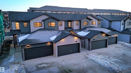 This property features a modern exterior design with mixed siding and stonework accents - 7694 174A Avenue, Edmonton, AB - Outdoor