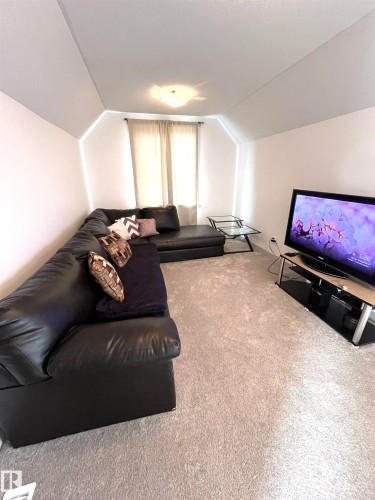This living area features light-colored carpeting and white walls - 16464 15 Avenue, Edmonton, AB - Indoor