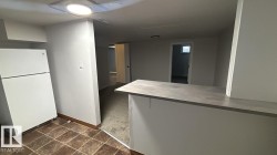 Kitchen with freestanding refrigerator and light countertops - 