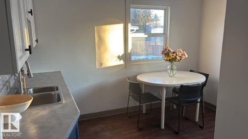 Dining space featuring dark wood-style flooring and baseboards - 13023 Sherbrooke Avenue, Edmonton, AB - Indoor