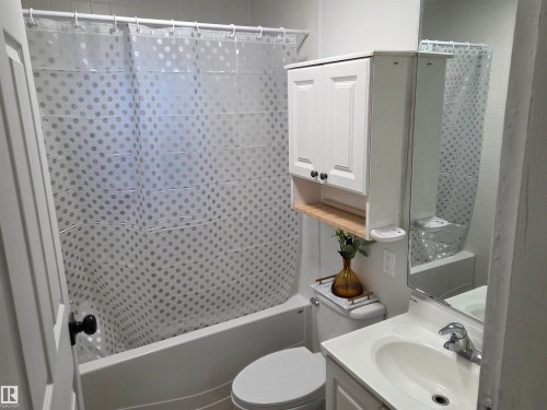 Bathroom featuring vanity and shower / bathtub combination with curtain - 13023 Sherbrooke Avenue, Edmonton, AB - Indoor Photo Showing Bathroom