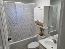 Bathroom featuring vanity and shower / bathtub combination with curtain - 