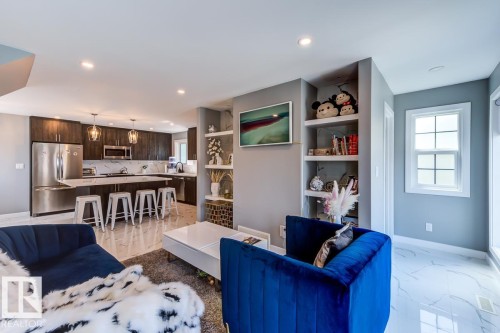 Open concept living area featuring recessed lighting, built-in shelving, and white tile flooring - 9526 109A Avenue, Edmonton, AB - Indoor Photo Showing Living Room