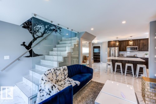 This inviting living area features sleek tile flooring, an elegant glass staircase with a modern railing, and recessed lighting - 9526 109A Avenue, Edmonton, AB - Indoor Photo Showing Kitchen
