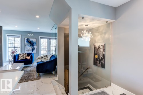 Living area featuring recessed lighting, a light gray wall, and two windows providing natural light - 9526 109A Avenue, Edmonton, AB - Indoor