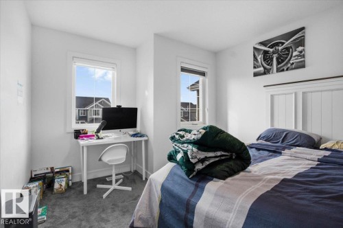 Bedroom featuring white walls, carpeting, and two windows providing natural light - 16624 32 Avenue, Edmonton, AB - Indoor Photo Showing Bedroom