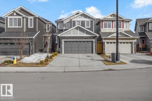 The property features a two-story design with a concrete driveway and an attached garage - 16624 32 Avenue, Edmonton, AB - Outdoor With Facade