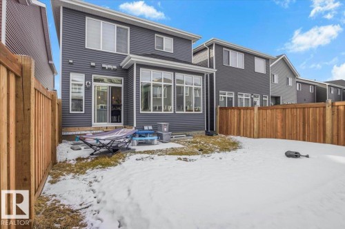 The property features a private yard with a wooden fence and a patio area - 16624 32 Avenue, Edmonton, AB - Outdoor