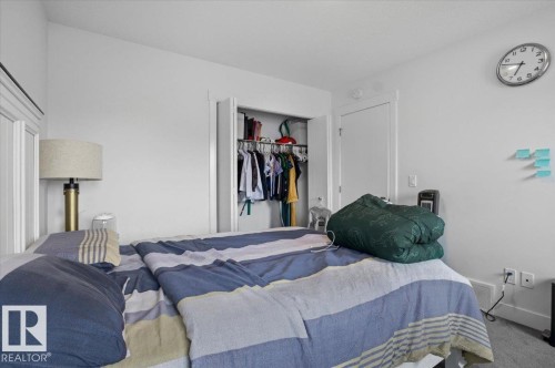 The property features a bedroom with a built-in closet and a white paneled headboard - 16624 32 Avenue, Edmonton, AB - Indoor Photo Showing Bedroom