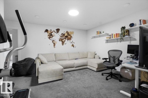 This versatile interior space features a plush carpet, recessed lighting, and white walls - 16624 32 Avenue, Edmonton, AB - Indoor