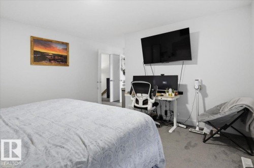 This room features light gray walls and gray carpeting, providing a neutral backdrop - 16624 32 Avenue, Edmonton, AB - Indoor Photo Showing Bedroom