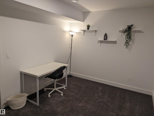 This room features white walls, dark gray carpeting, and recessed lighting - 16624 32 Avenue, Edmonton, AB - Indoor