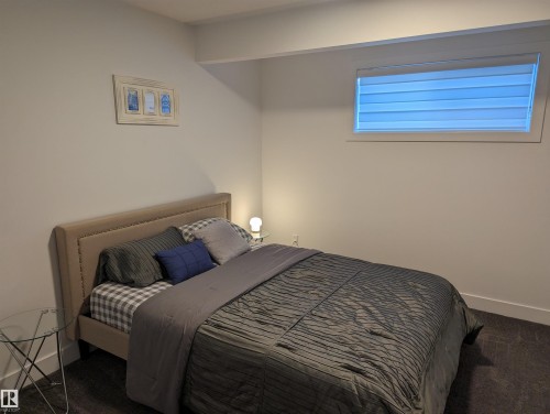 This room features a window with blinds, light-colored walls, and a recessed ceiling beam - 16624 32 Avenue, Edmonton, AB - Indoor Photo Showing Bedroom