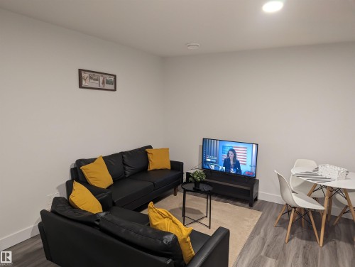 Living area featuring light-colored walls, recessed lighting, and wood-look flooring - 16624 32 Avenue, Edmonton, AB - Indoor Photo Showing Living Room