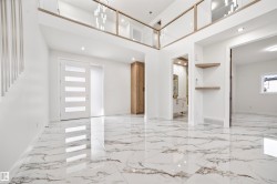 The interior features polished marble-look tile flooring and white walls, creating a bright and expansive atmosphere - 