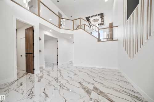 The property features a spacious entrance with large format marble-look tile flooring - 423 Robinson Boulevard, Leduc, AB - Indoor Photo Showing Other Room