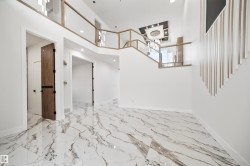 The property features a spacious entrance with large format marble-look tile flooring - 