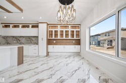 Expansive open-concept living area featuring a contemporary lighting fixture, large windows, and sleek marble-patterned flooring - 